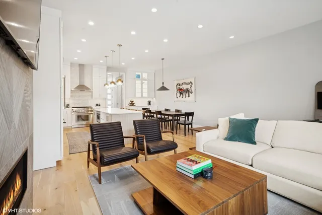 a living room with furniture and a dining table with kitchen view