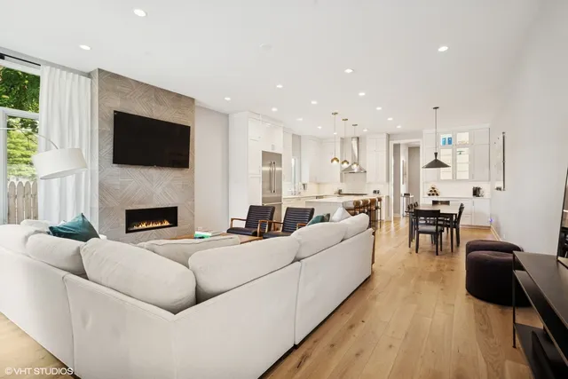 a living room with furniture a fireplace and a flat screen tv