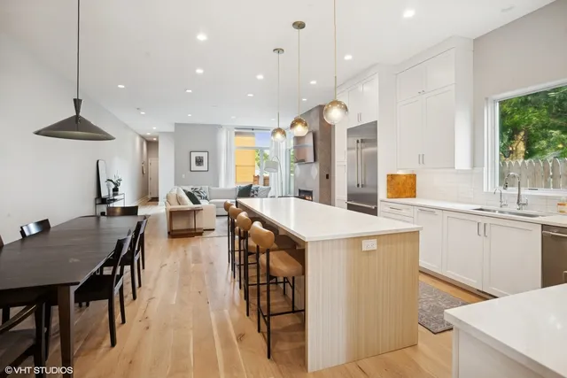 a kitchen with counter space dining table and chairs
