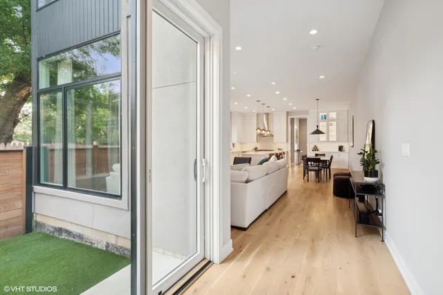 a open kitchen with white cabinets and wooden floor