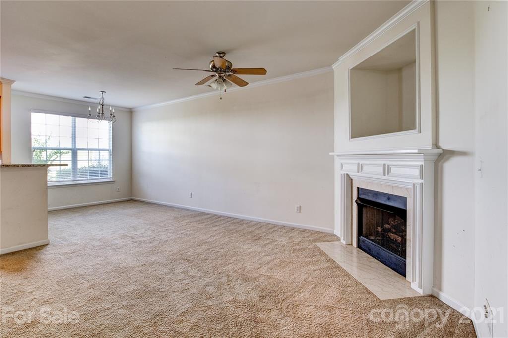 1310 Smokey Quartz Lane Fort Mill, SC 29708 - Photo 3 of 18 an empty room with windows and fireplace