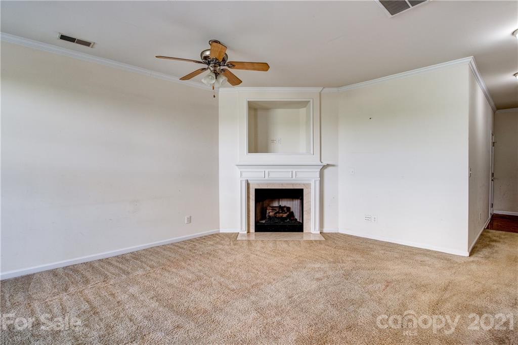 1310 Smokey Quartz Lane Fort Mill, SC 29708 - Photo 4 of 18 a view of an empty room with a fireplace and a window