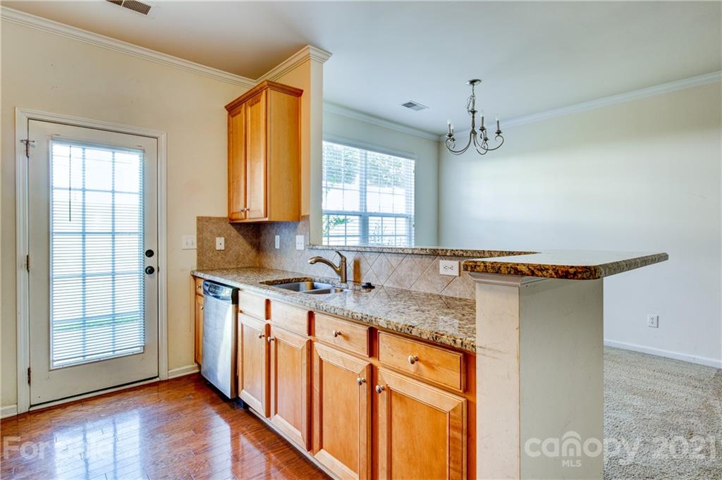 1310 Smokey Quartz Lane Fort Mill, SC 29708 - Photo 7 of 18 a kitchen with stainless steel appliances granite countertop a sink stove and cabinets