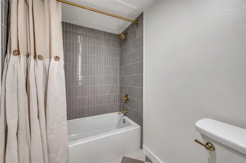 a bathroom with a bathtub and a toilet