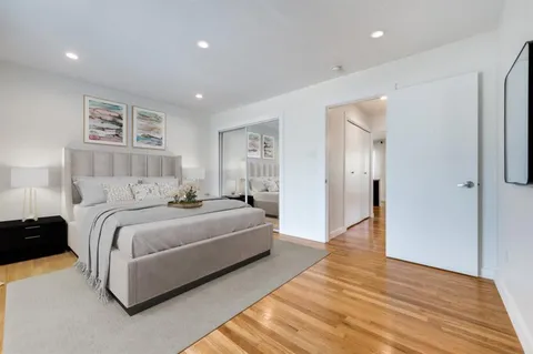 a spacious bedroom with a bed and a walk in closet