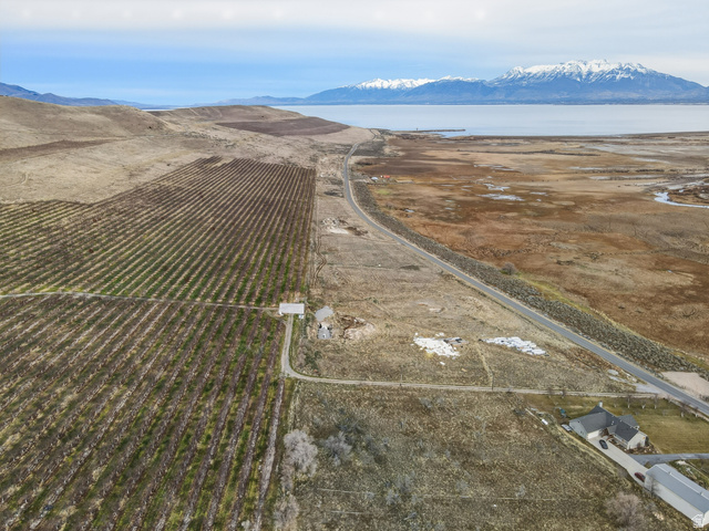5952 South Lincoln Road Spanish Fork, UT 84660 - Photo 14 of 15 Aerial view of property and surrounding area featuring rural landscape, a mountainous background, and abundant farmland