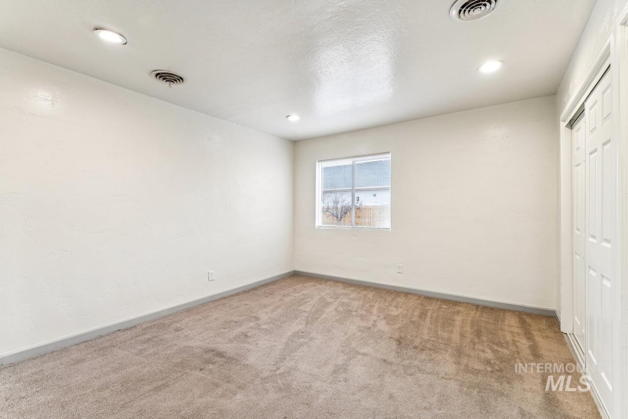 317 East Ithaca Street Caldwell, ID 83605 - Photo 15 of 49 Unfurnished bedroom featuring carpet flooring, a closet, and recessed lighting