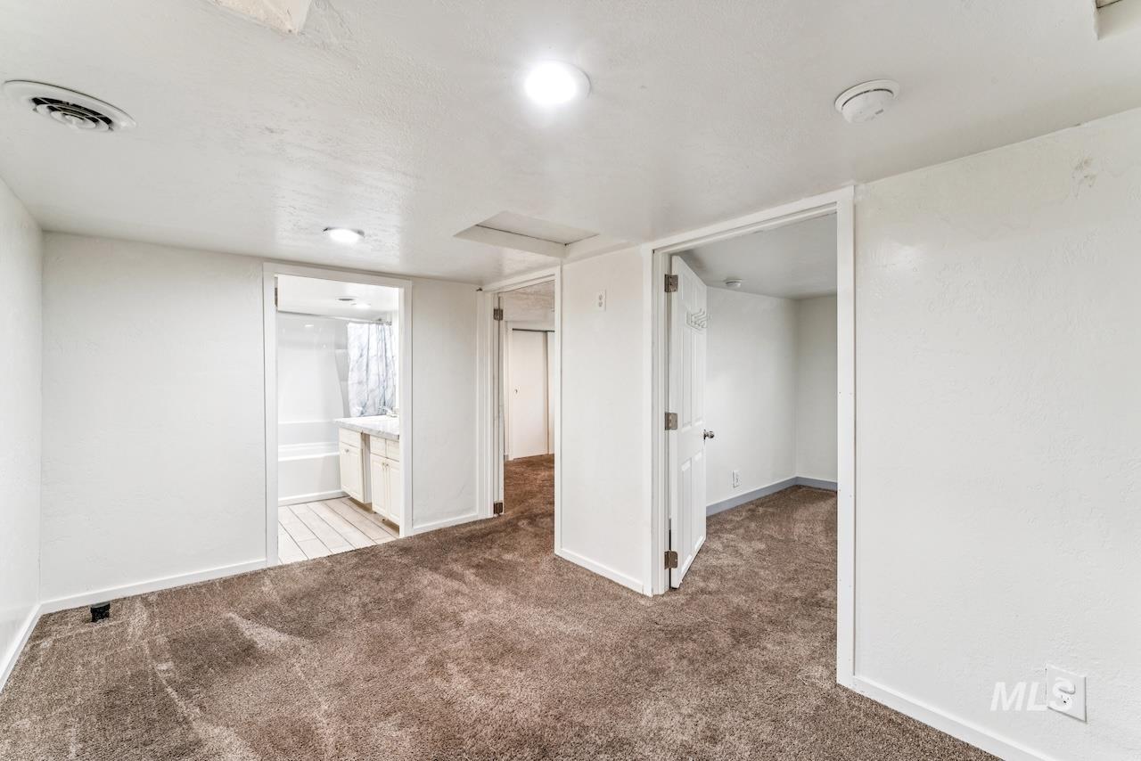 317 East Ithaca Street Caldwell, ID 83605 - Photo 23 of 49 Unfurnished bedroom featuring light colored carpet and ensuite bath