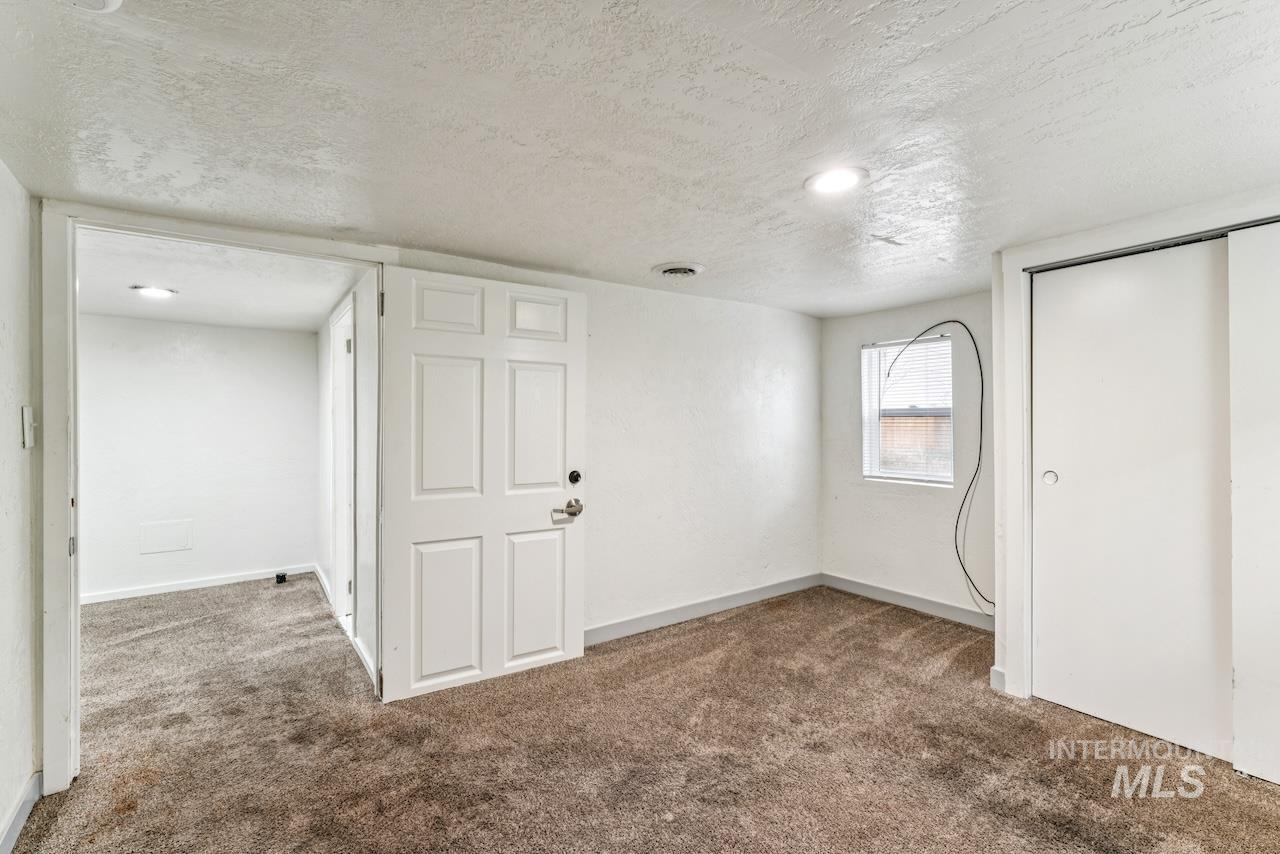 317 East Ithaca Street Caldwell, ID 83605 - Photo 25 of 49 Unfurnished bedroom with a textured ceiling, carpet floors, and a closet