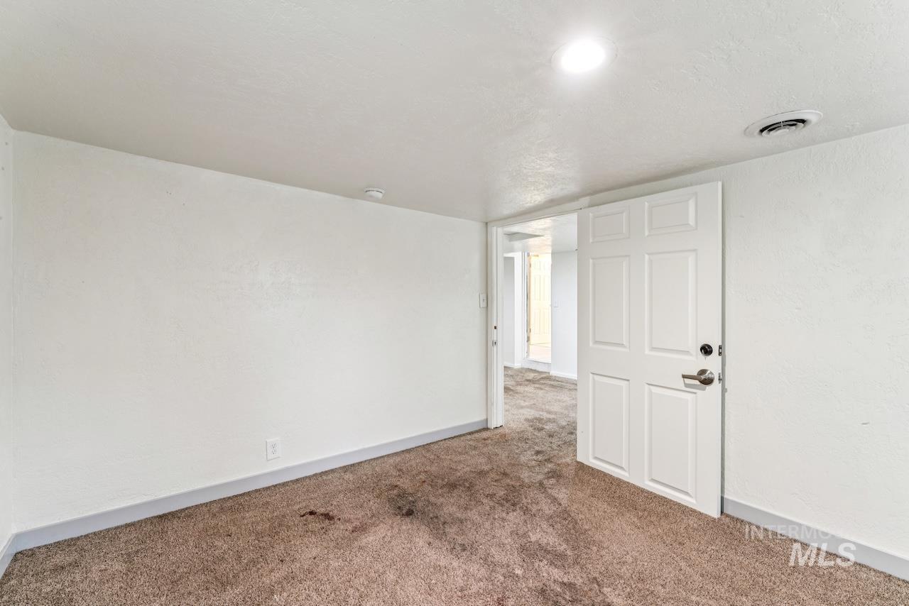 317 East Ithaca Street Caldwell, ID 83605 - Photo 26 of 49 Carpeted spare room with baseboards