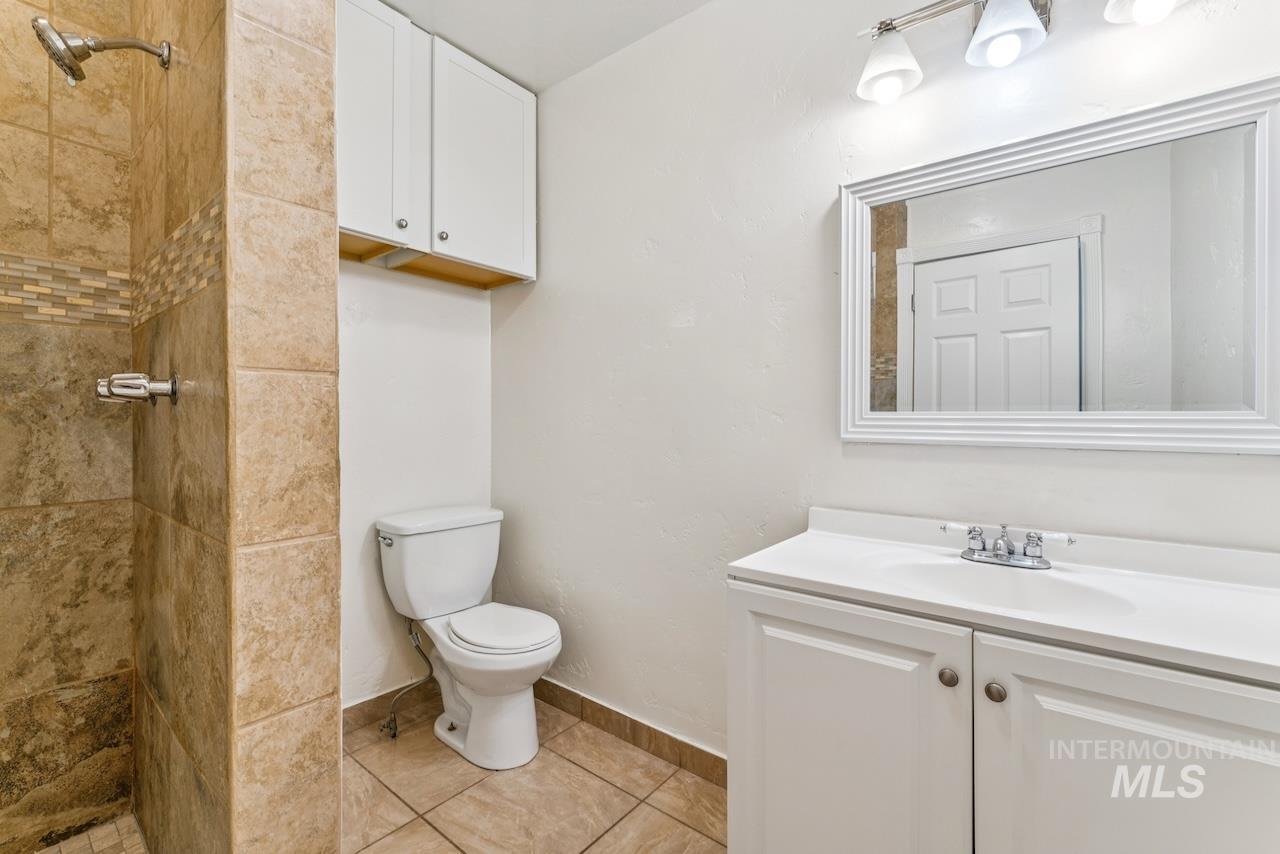 317 East Ithaca Street Caldwell, ID 83605 - Photo 33 of 49 Full bath with a shower stall, vanity, and light tile patterned floors