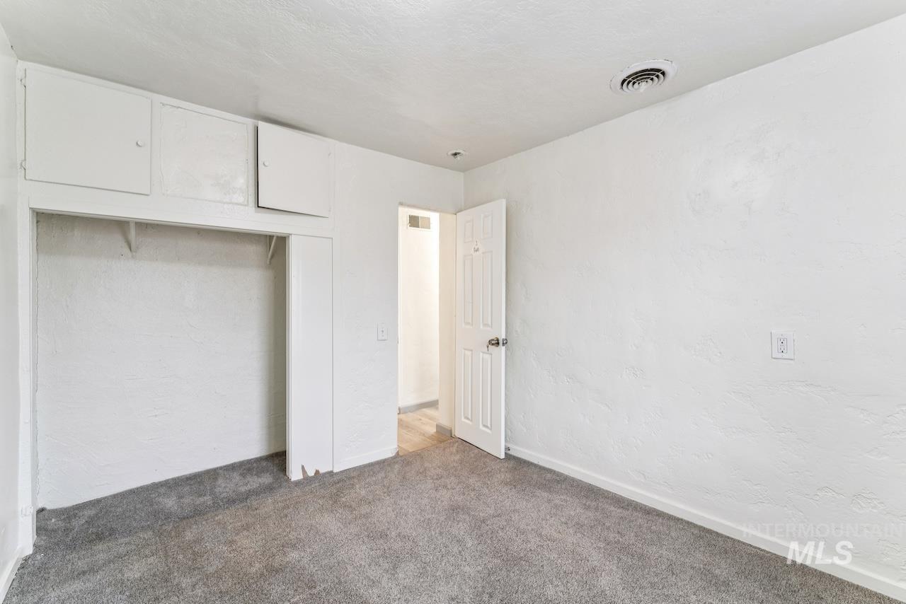 317 East Ithaca Street Caldwell, ID 83605 - Photo 43 of 49 Unfurnished bedroom with a textured wall, a closet, and carpet floors
