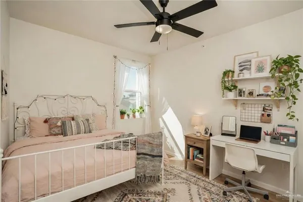 a bedroom with furniture and a window
