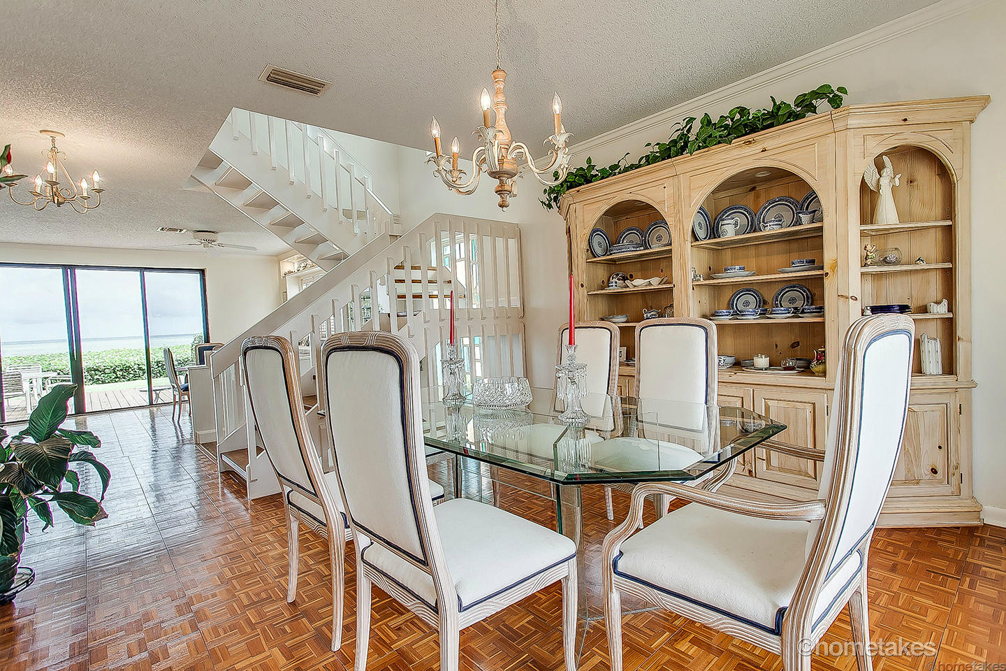170 Celestial Way, Unit 46 Juno Beach, FL 33408 - Photo 13 of 33 a view of a dining room with furniture chandelier and wooden floor