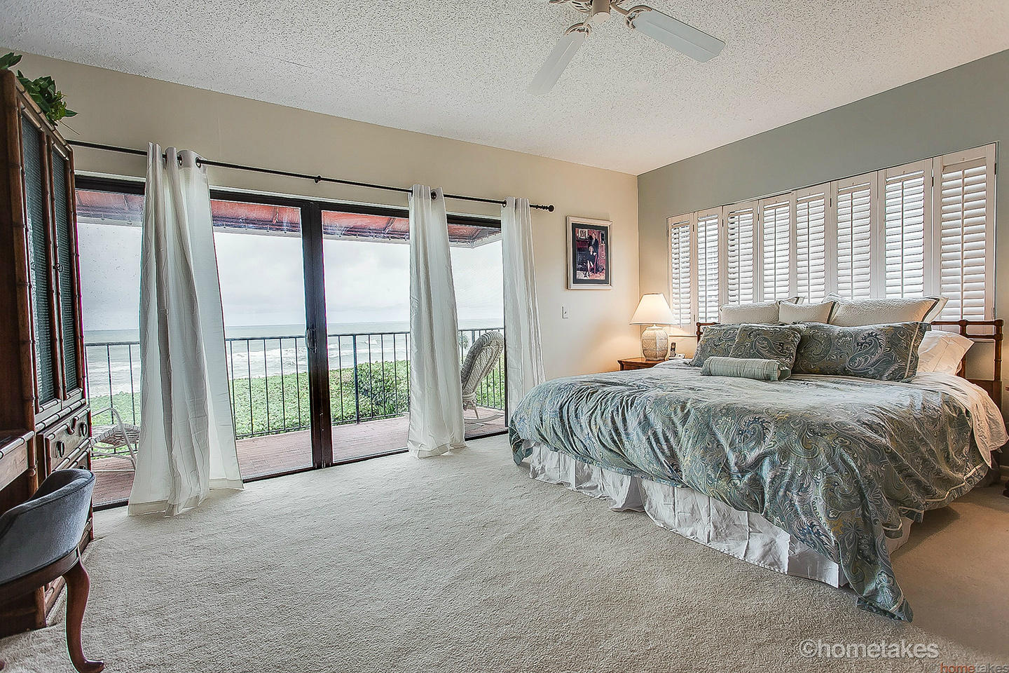 170 Celestial Way, Unit 46 Juno Beach, FL 33408 - Photo 16 of 33 a spacious bedroom with a bed and a flat tv screen