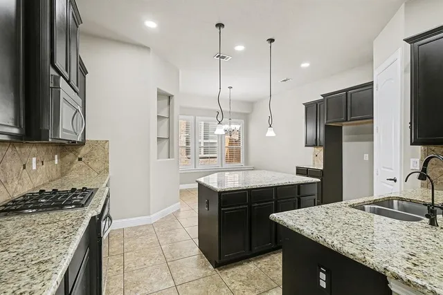 a kitchen with a stove sink and refrigerator