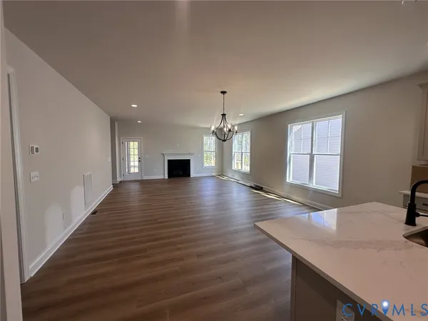 a view of a kitchen with wooden floor and a kitchen