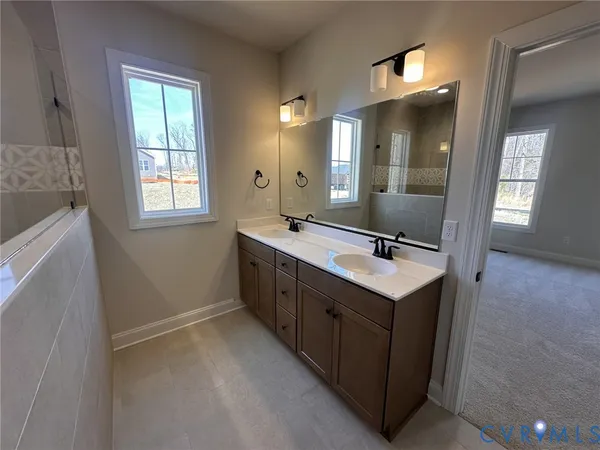 a bathroom with a sink double vanity and a mirror