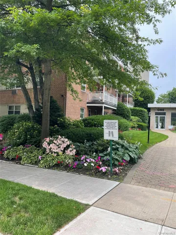 a front view of a house with a yard and a garage