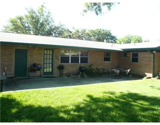 a backyard of a house with yard and outdoor seating