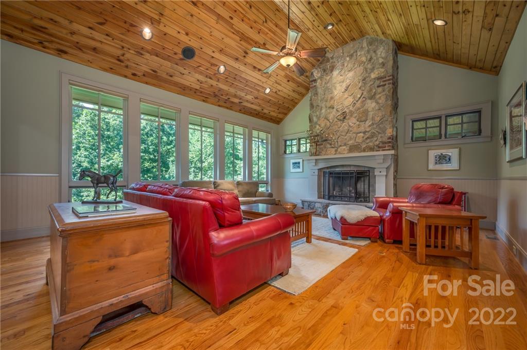 1360 South Phillips Road Columbus, NC 28722 - Photo 12 of 41 a living room with furniture a fireplace and a table