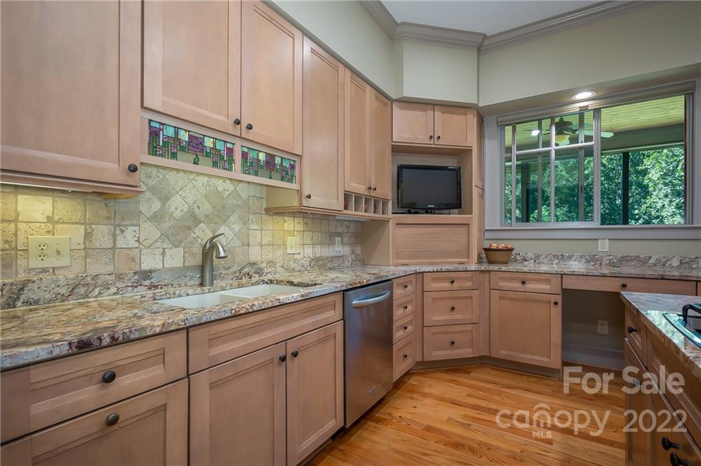 1360 South Phillips Road Columbus, NC 28722 - Photo 16 of 41 a kitchen with granite countertop stainless steel appliances a sink and cabinets