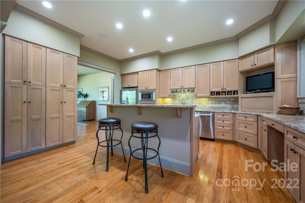 1360 South Phillips Road Columbus, NC 28722 - Photo 18 of 41 a kitchen with stainless steel appliances granite countertop wooden cabinets a stove top oven a sink and dishwasher with wooden floor
