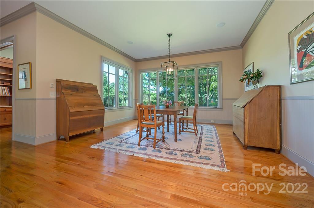 1360 South Phillips Road Columbus, NC 28722 - Photo 19 of 41 a dining room with furniture a chandelier and wooden floor