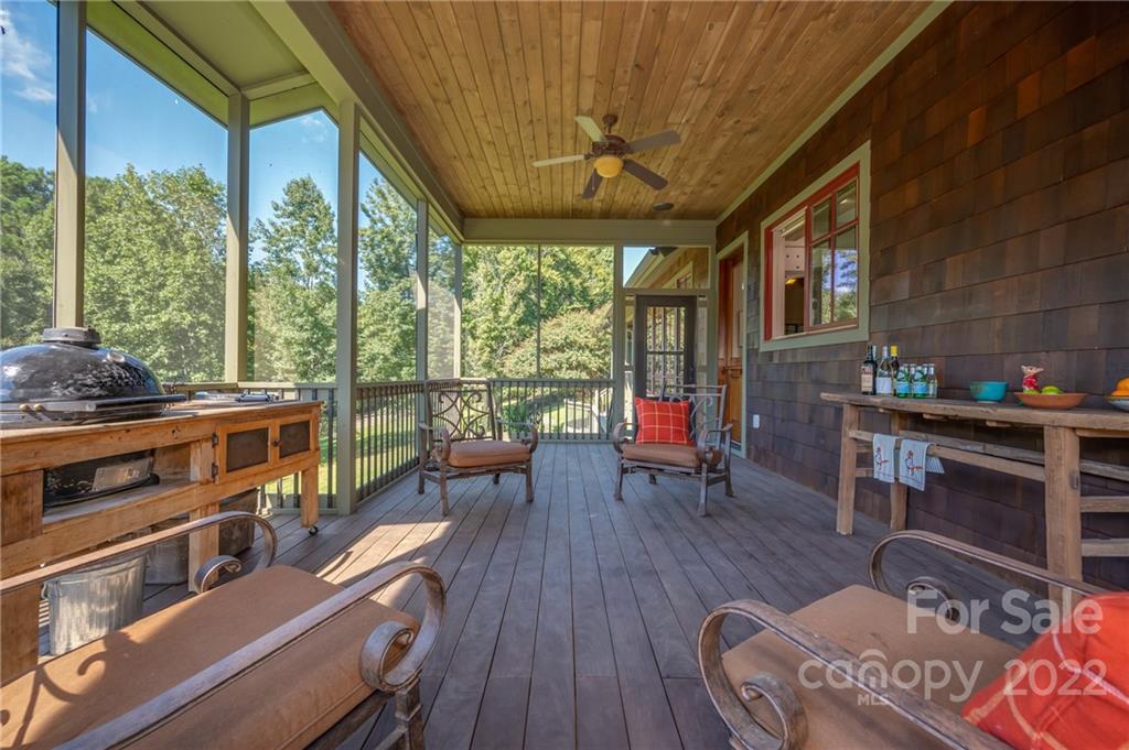 1360 South Phillips Road Columbus, NC 28722 - Photo 21 of 41 a living room with furniture a fireplace and large windows