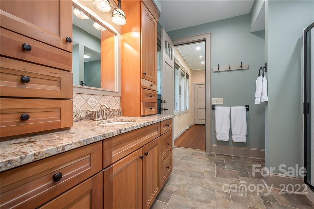 1360 South Phillips Road Columbus, NC 28722 - Photo 33 of 41 a bathroom with a granite countertop sink and a mirror