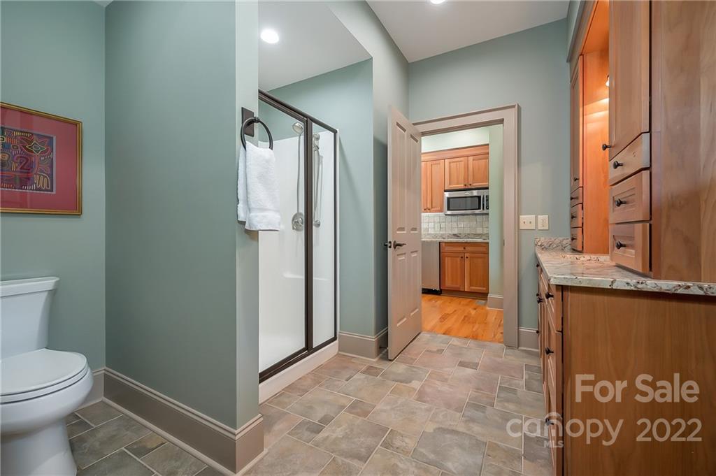 1360 South Phillips Road Columbus, NC 28722 - Photo 34 of 41 a bathroom with a granite countertop sink and a mirror