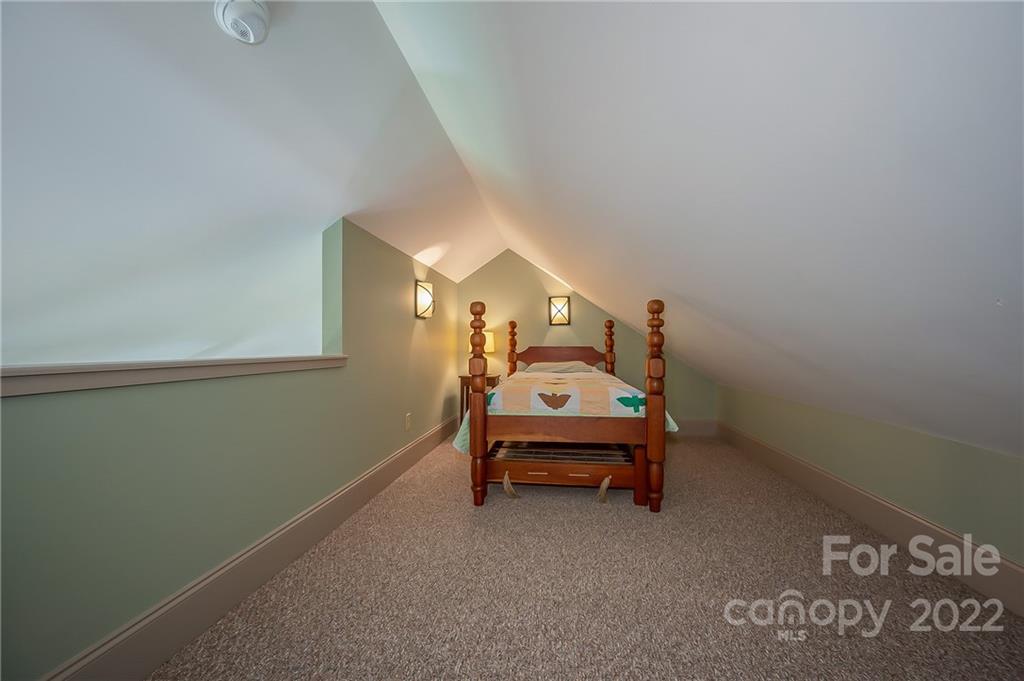 1360 South Phillips Road Columbus, NC 28722 - Photo 35 of 41 a bedroom with a bed and a lamp on the dresser