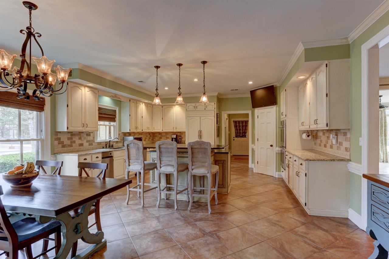 2420 Johnson Road Germantown, TN 38139 - Photo 11 of 25 This picture is looking from the dining room into the kitchen. Lots of cabinets and countertop room. Down the hallway is the laundry room and a full bathroom.