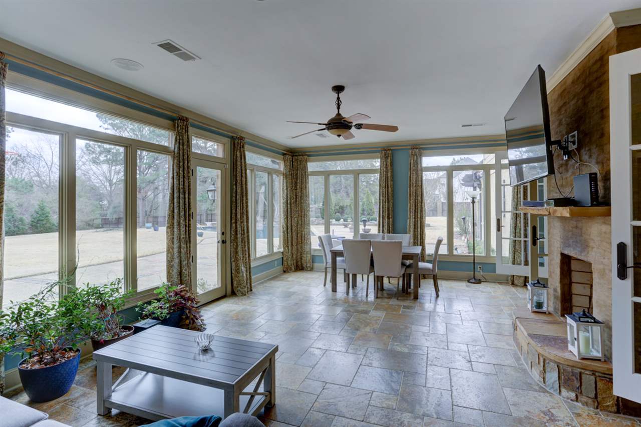 2420 Johnson Road Germantown, TN 38139 - Photo 13 of 25 Look at all the beautiful windows that look out over the pool area. The double sided fireplace is shared with the den on the other side. So relaxing.