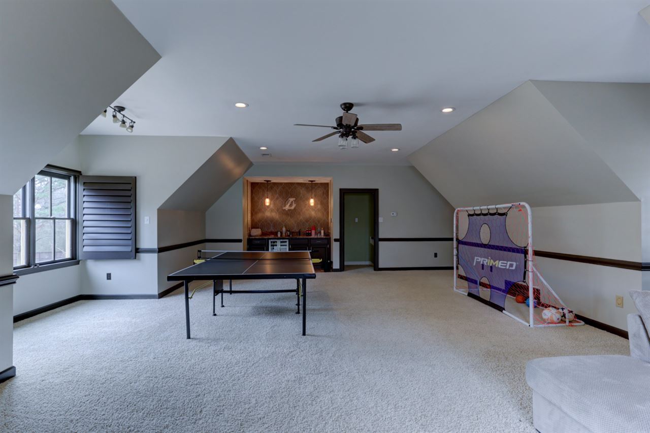 2420 Johnson Road Germantown, TN 38139 - Photo 24 of 25 The bonus room has rear stairs going down to the hallway leading to the kitchen area and sunroom. Also equipped with a wet bar.