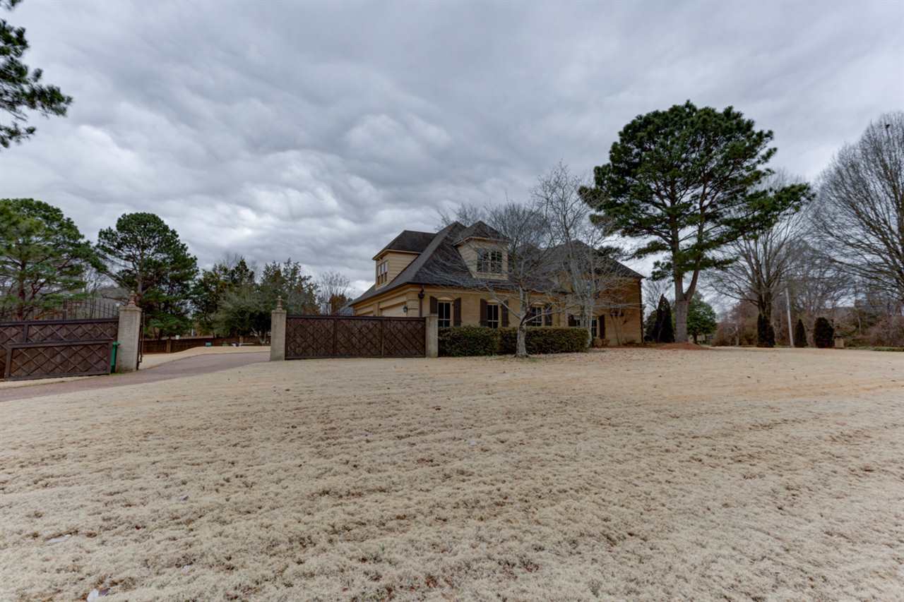 2420 Johnson Road Germantown, TN 38139 - Photo 4 of 25 The home sits on a corner lot. This back driveway has an electric gate that leads up to two double garages.