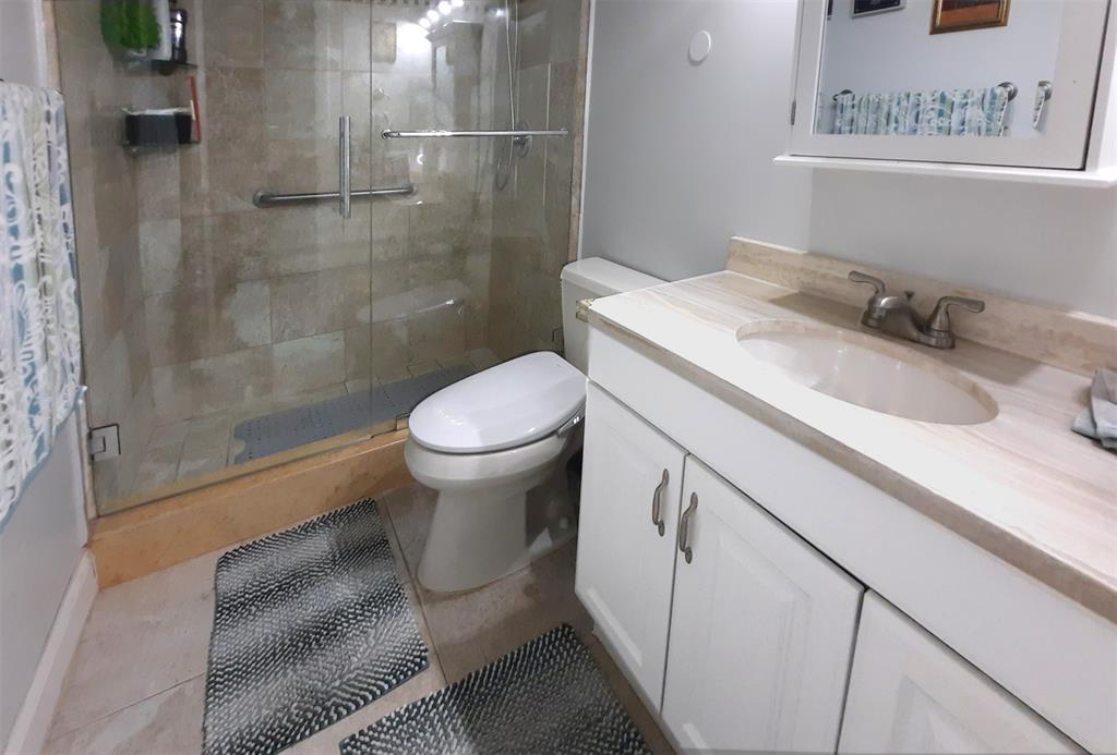 291 South Hollybrook Drive, Unit 305 Pembroke Pines, FL 33025 - Photo 5 of 16 a bathroom with a sink toilet and shower