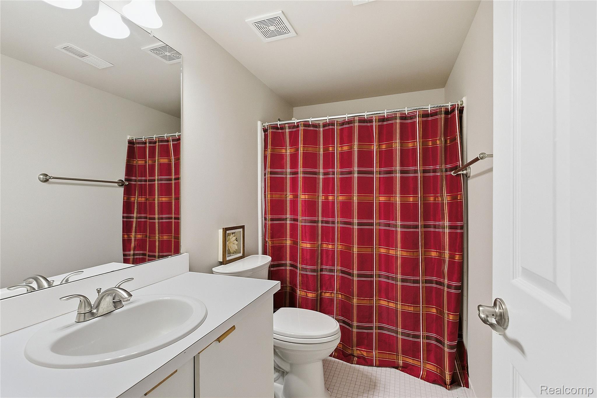 7154 Westchester Road West Bloomfield, MI 48322 - Photo 12 of 38 Full bath featuring vanity, curtained shower, and tile patterned floors