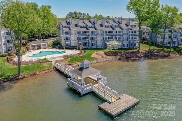 a view of swimming pool with outdoor seating and lake view