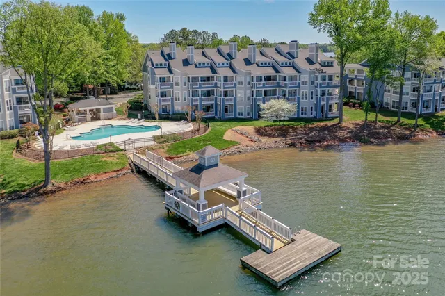 a view of swimming pool with outdoor seating and lake view