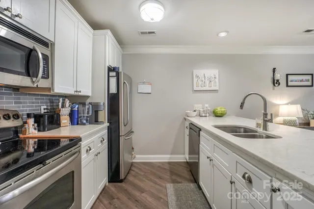 a bathroom with a sink a toilet and large mirror
