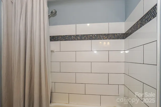 a bathroom with a granite countertop sink mirror toilet and bathtub