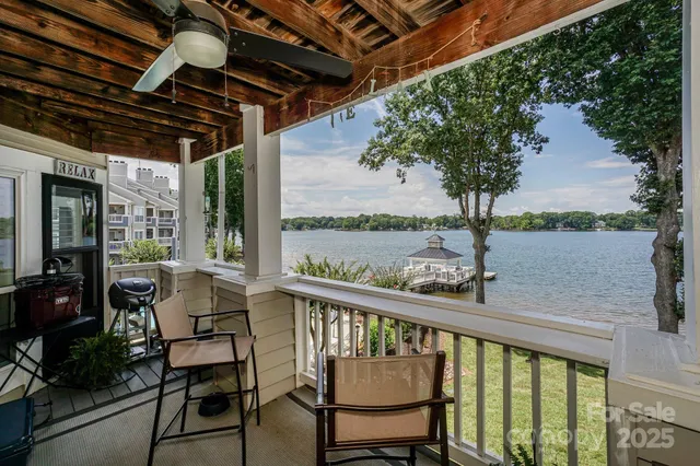 an aerial view of a house with outdoor space and lake view in back