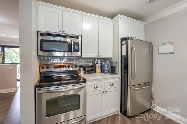 a living room with furniture a rug and a ceiling fan