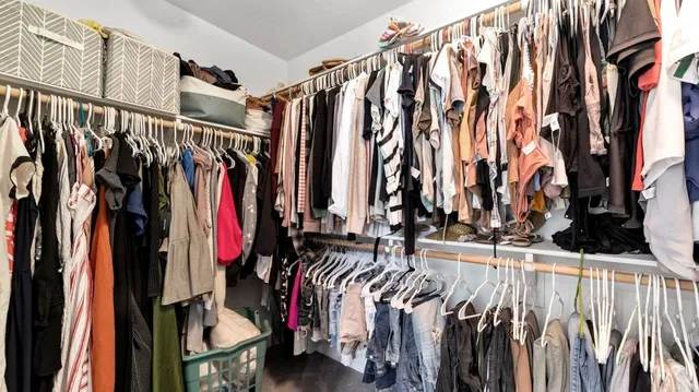 a view of walk in closet with clothes