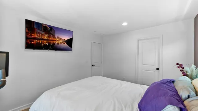 a bedroom with a bed and wall painting