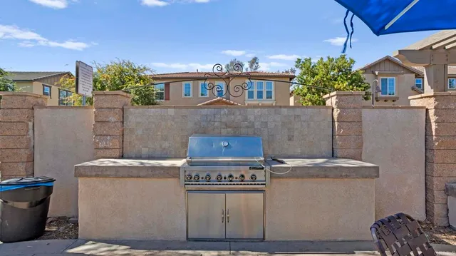 a view of a house with a yard and sitting area