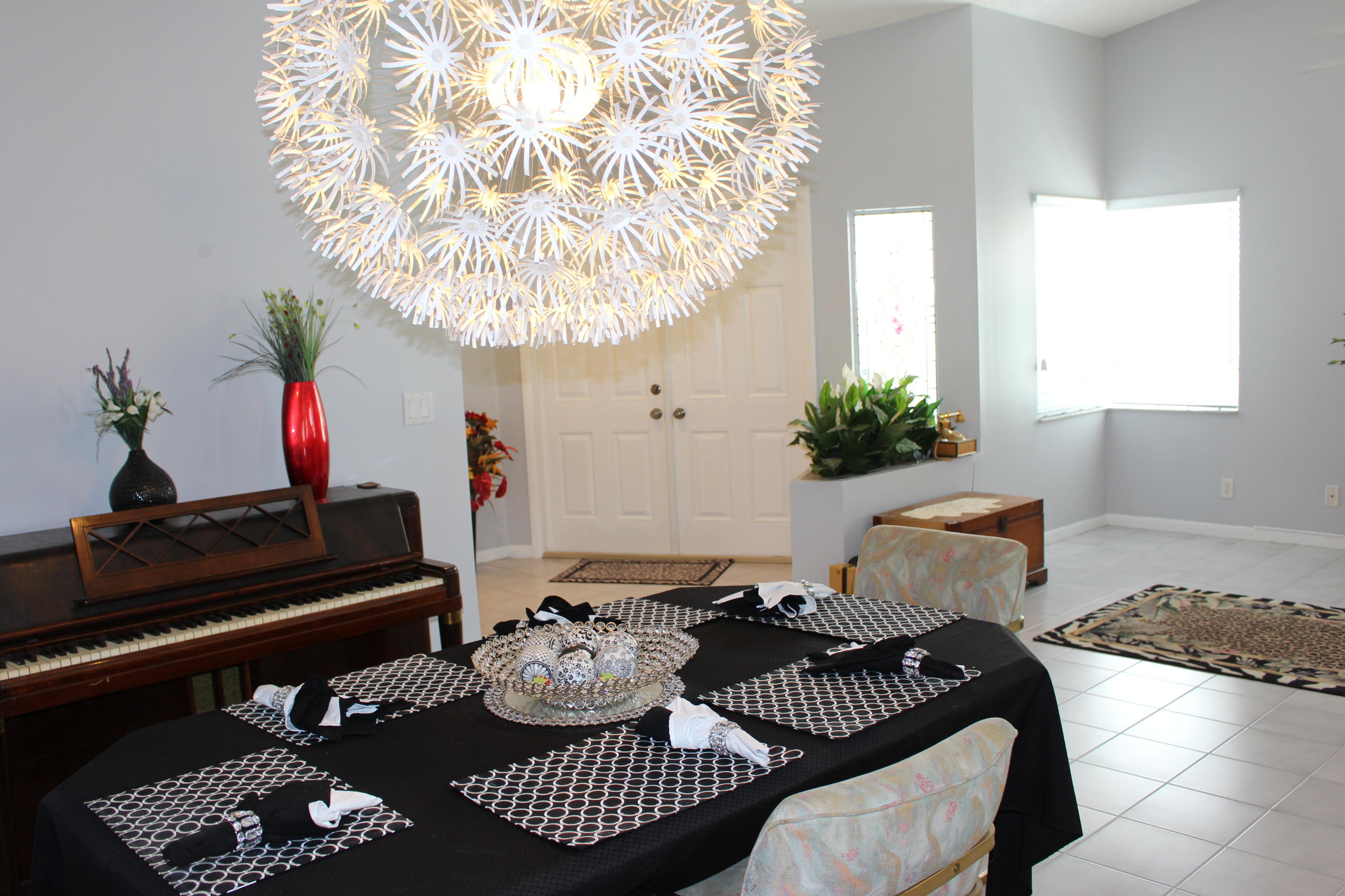 10012 Country Brook Road Boca Raton, FL 33428 - Photo 12 of 25 a living room with furniture and a chandelier