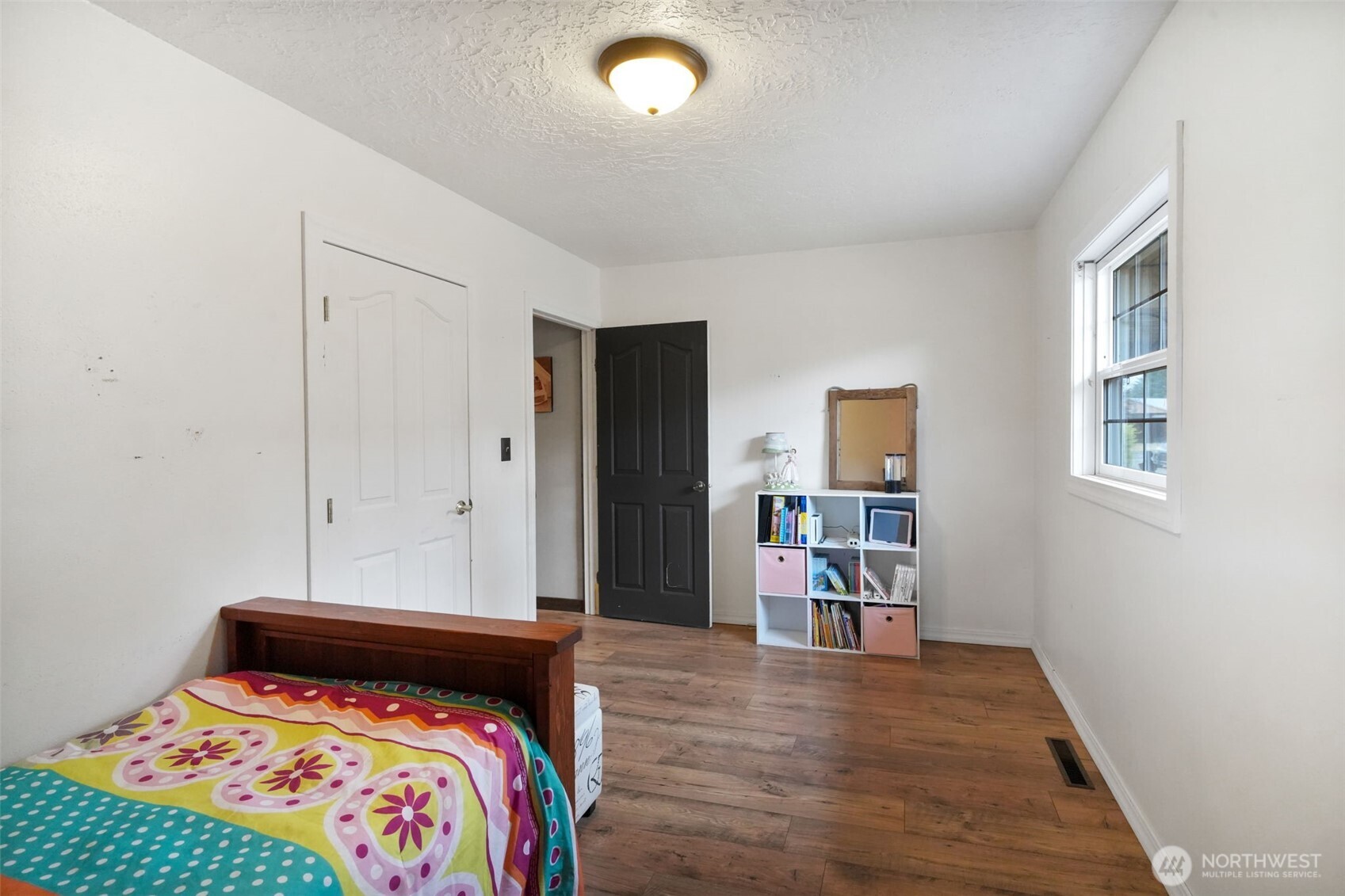 142 Drews Prairie Road Toledo, WA 98591 - Photo 17 of 33 a bedroom with a bed and a wooden floor