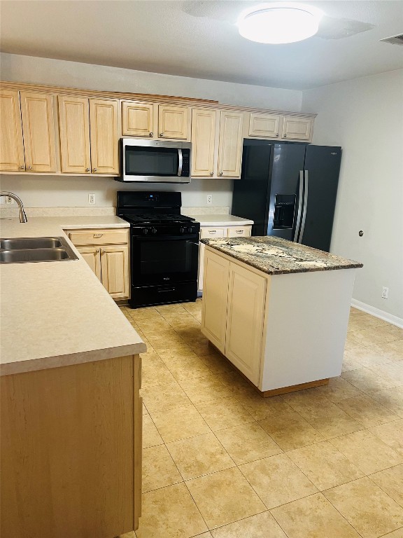 272 Tobin Drive Buda, TX 78610 - Photo 12 of 20 a kitchen with stainless steel appliances a stove a microwave and a sink